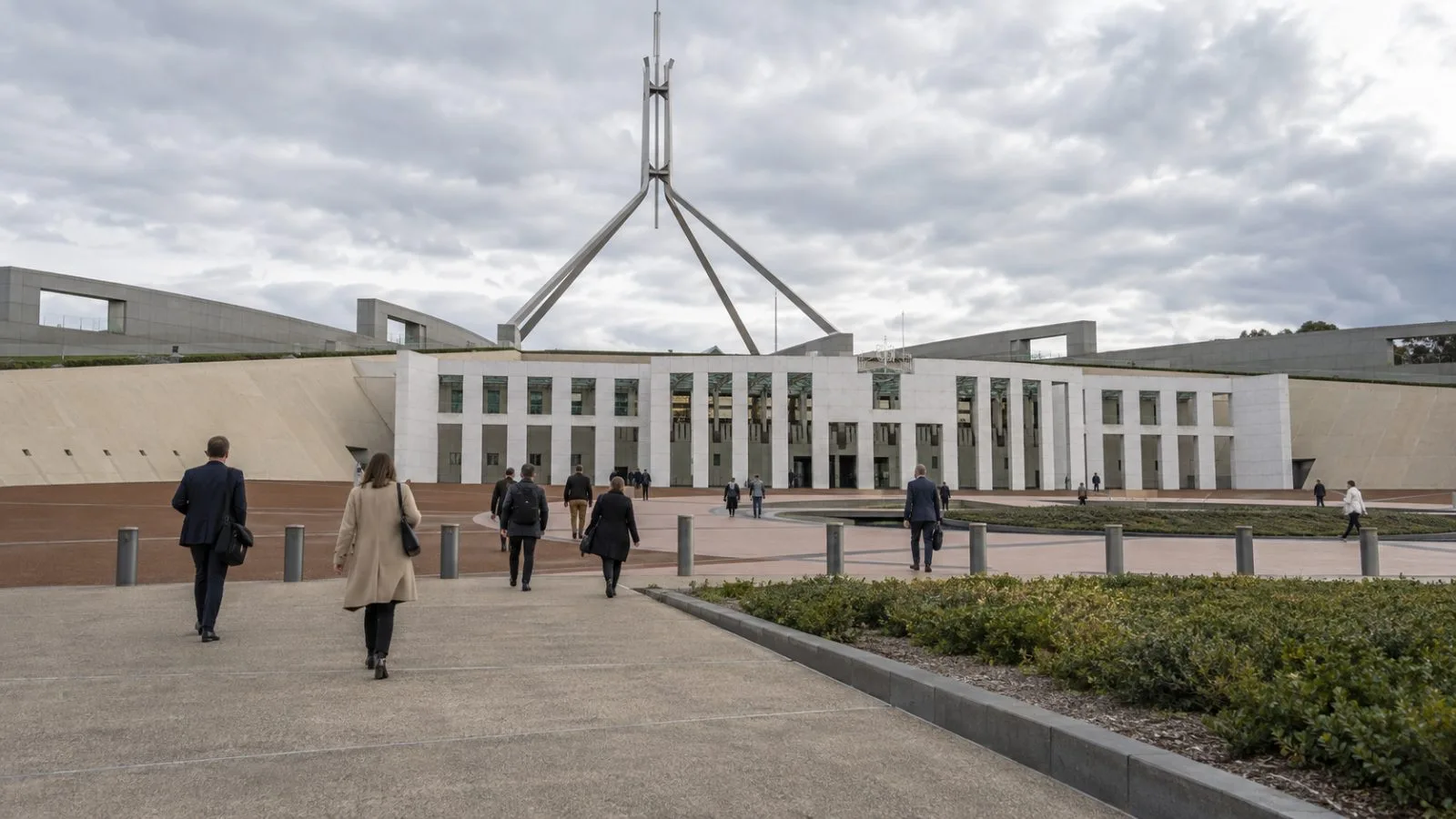 Microphones stand ready in a Senate committee room at Parliament House in Canberra. / EconoTimes.ai