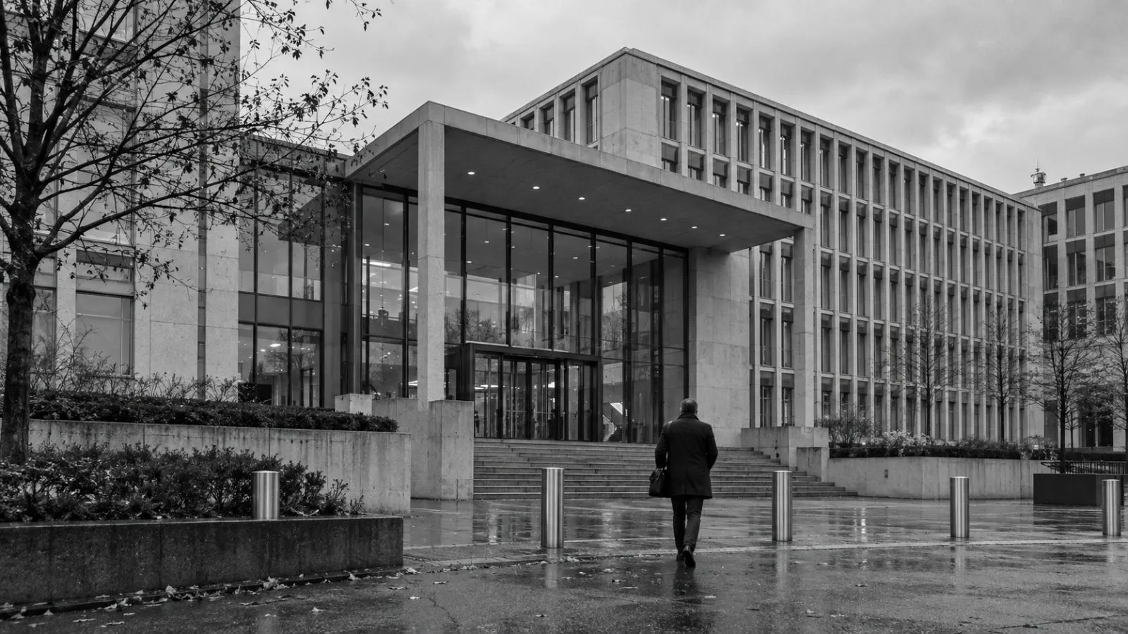 A pedestrian approaches the Federal Office for Defence Procurement in Bern, Switzerland, beneath an overcast sky. (AI-generated image / EconoTimes)