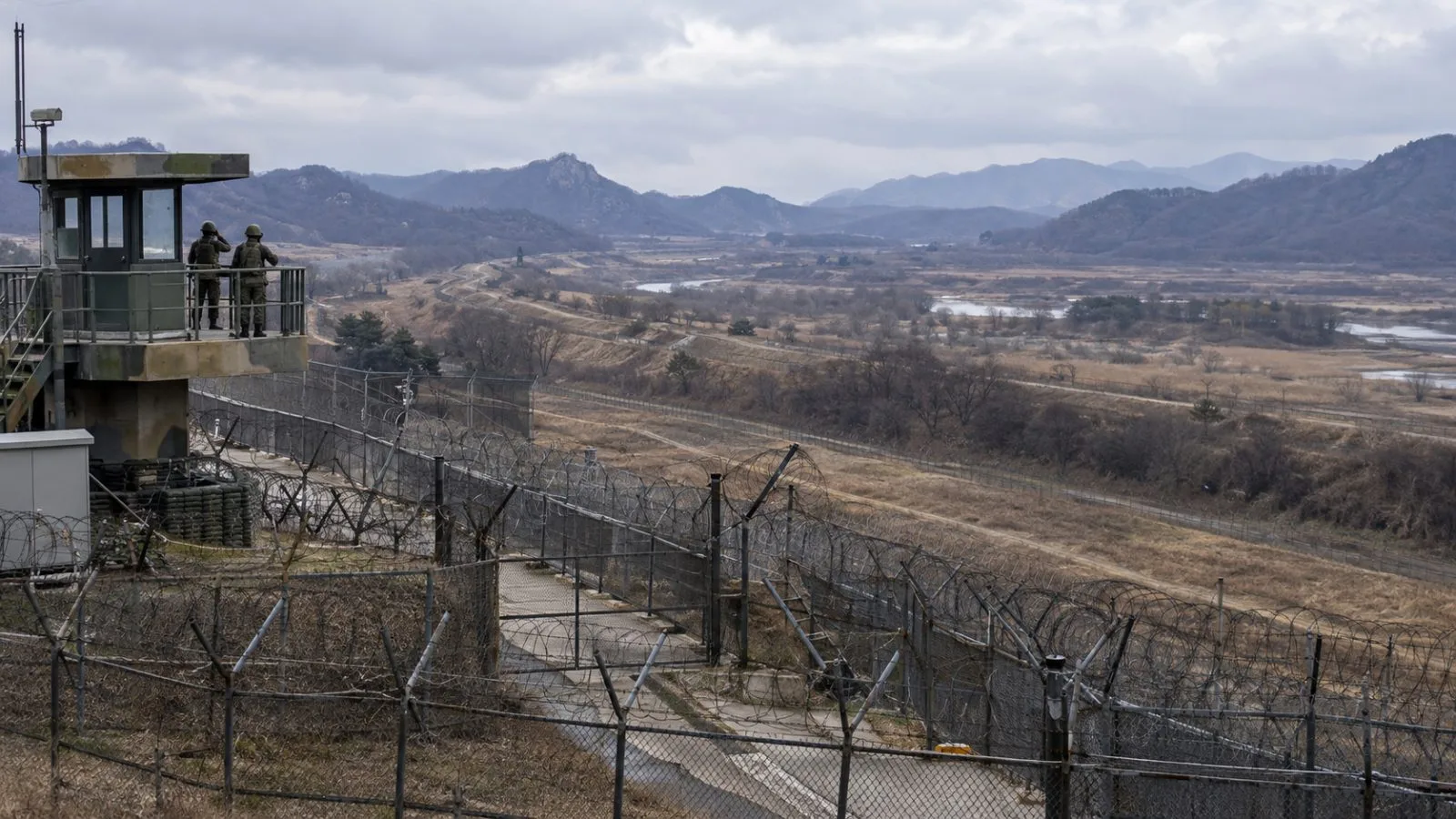 Border fencing and a guard post overlook the Demilitarized Zone near Paju, South Korea. (AI-generated image / EconoTimes)