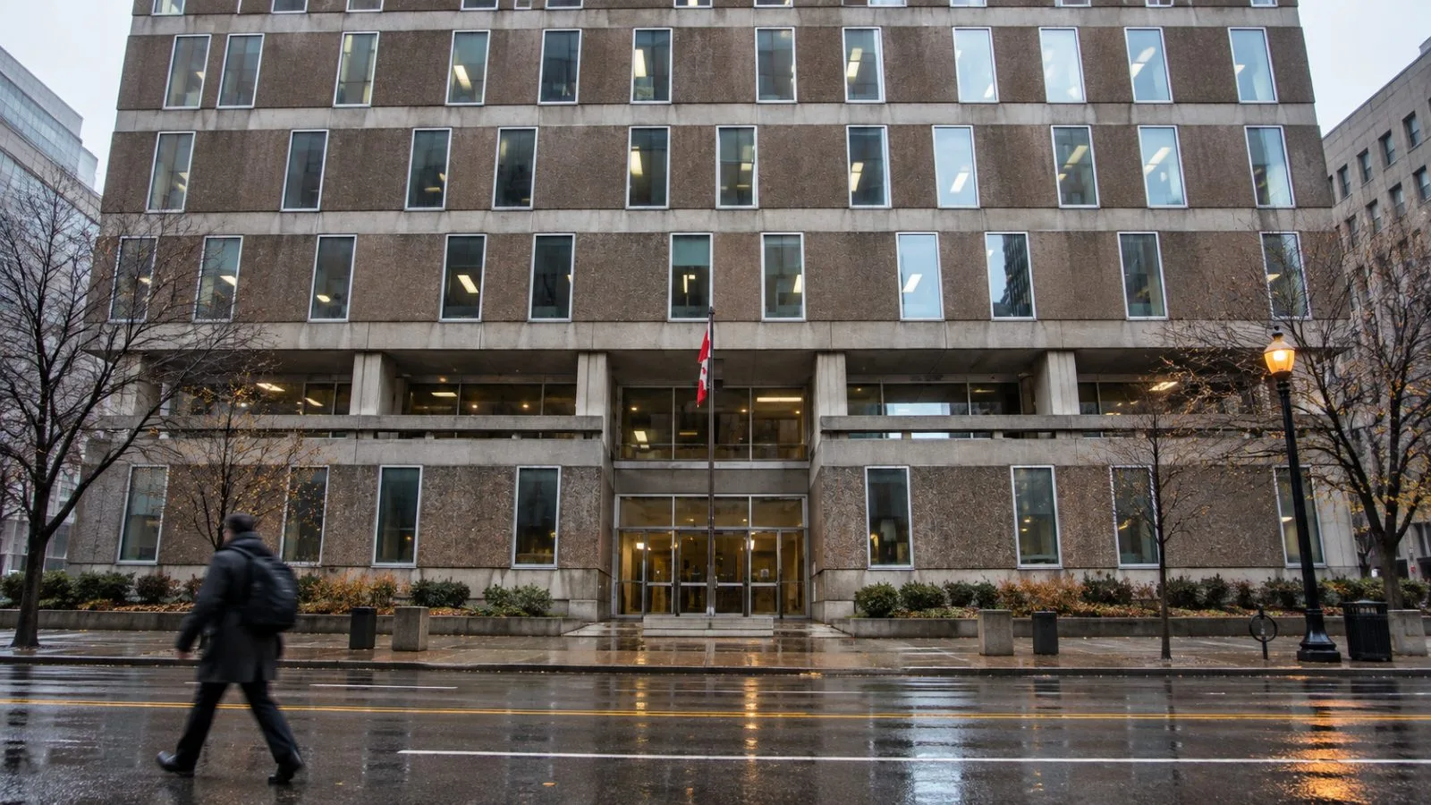A passerby crosses Laurier Avenue West outside the Correctional Service of Canada headquarters in Ottawa. / EconoTimes.ai