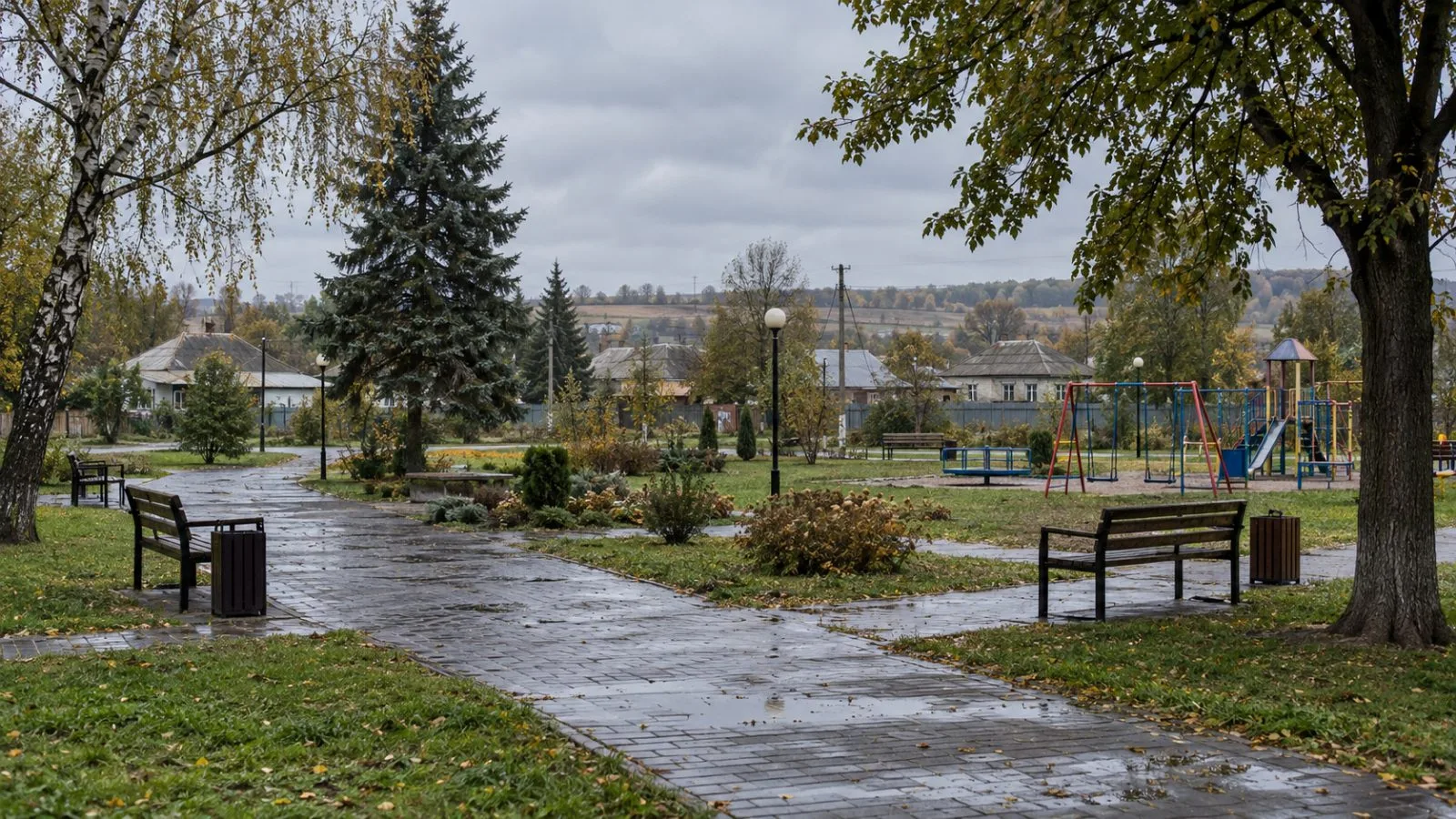 A village park stands empty southwest of Kharkiv, Ukraine, under overcast skies. (AI-generated image / EconoTimes)