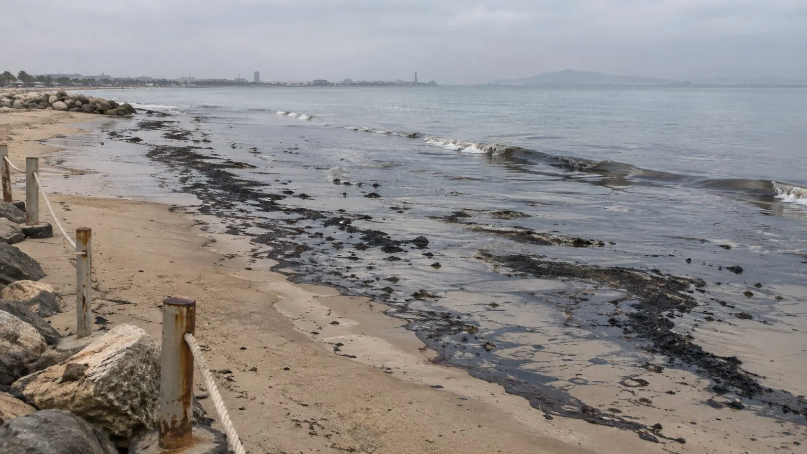 Dark oil residue lines the shoreline at a public beach in Ras Al Khaimah, UAE. (AI-generated image / EconoTimes)