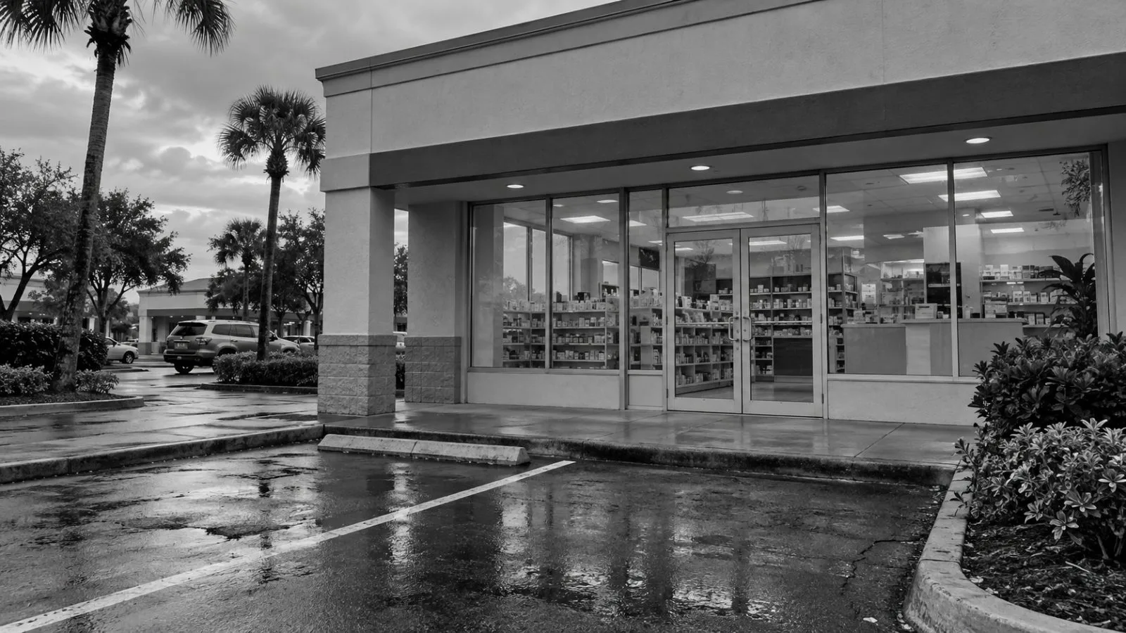 A locked pharmacy entrance sits along a commercial strip in Margate, Florida. (AI-generated image / EconoTimes)