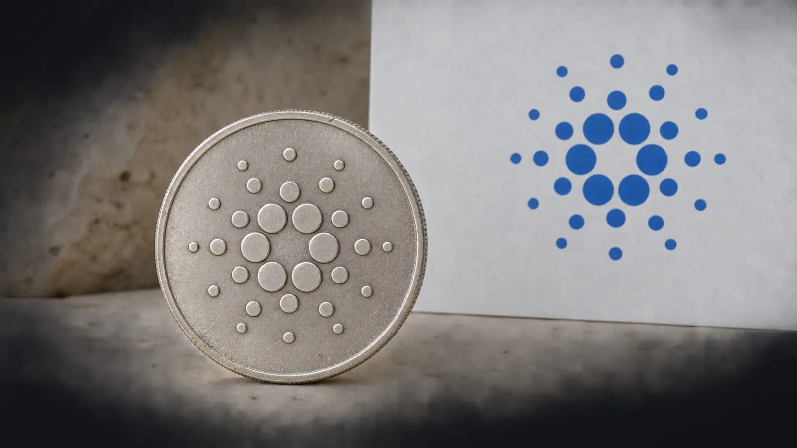 A stylized ADA token rests on a pale surface in an editorial market graphic. / EconoTimes.ai