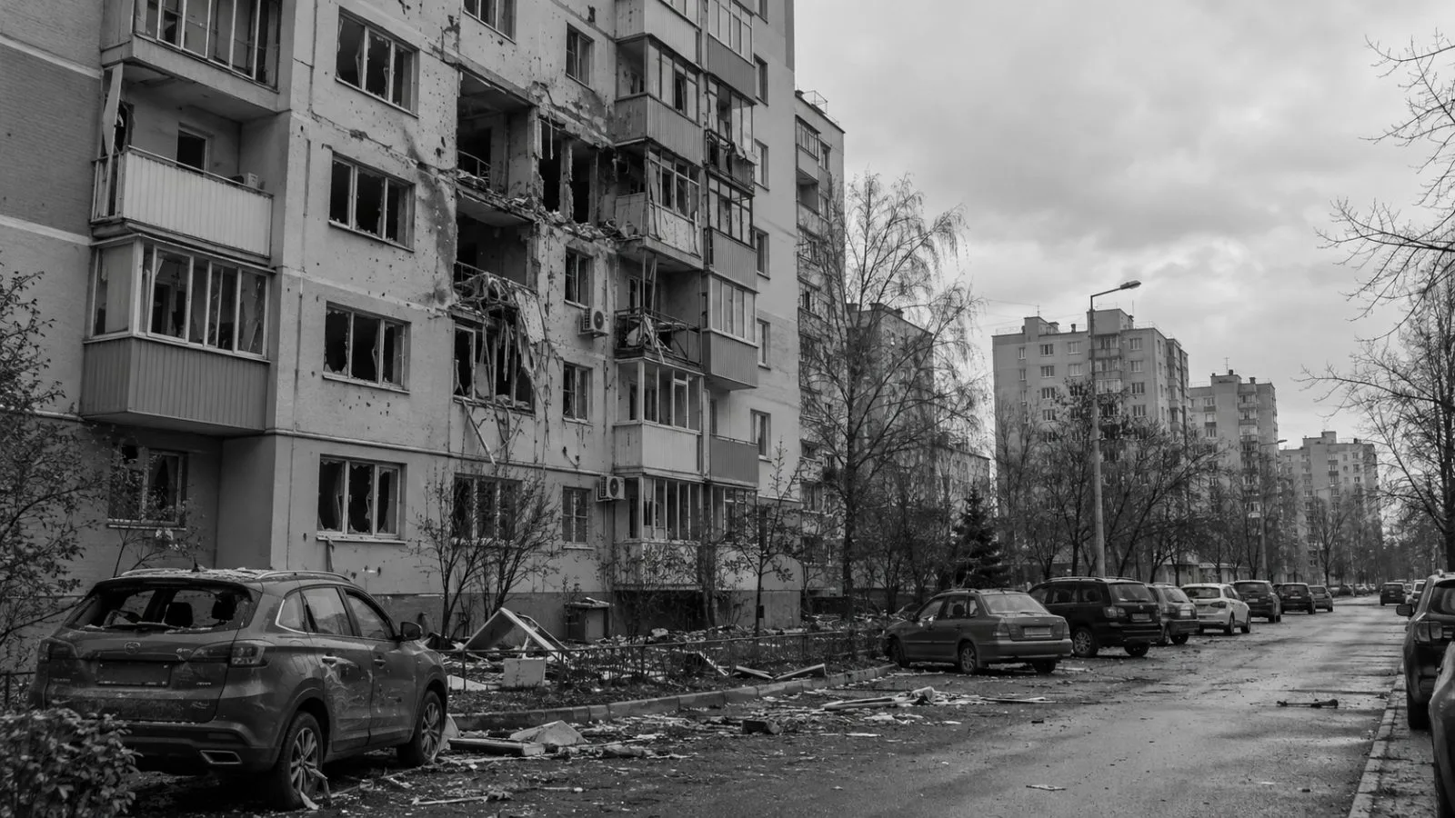 A damaged apartment block and parked cars line a residential street in Belgorod, Russia (AI-generated image / EconoTimes)