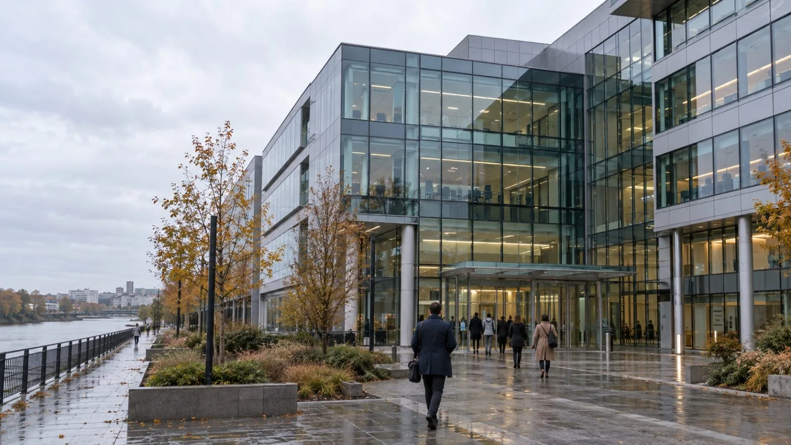 Employees enter the River Ouest office building in Bezons, France, on an overcast morning. (AI-generated image / EconoTimes)