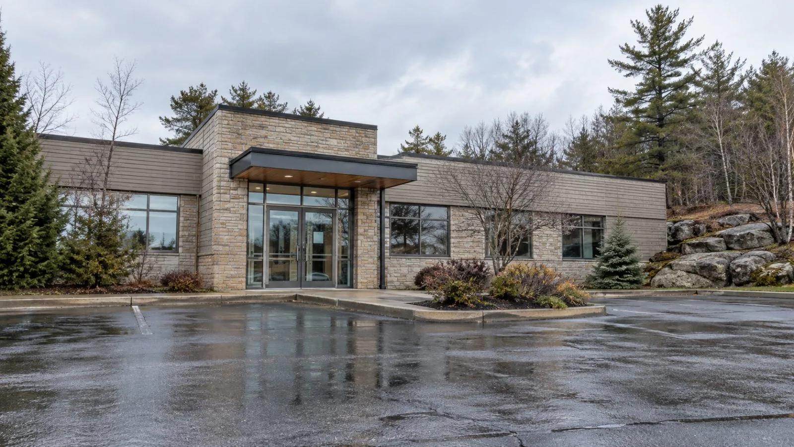 A modest office building stands on Crescent Road in Huntsville, Ontario, beneath an overcast autumn sky. (AI-generated image / EconoTimes)