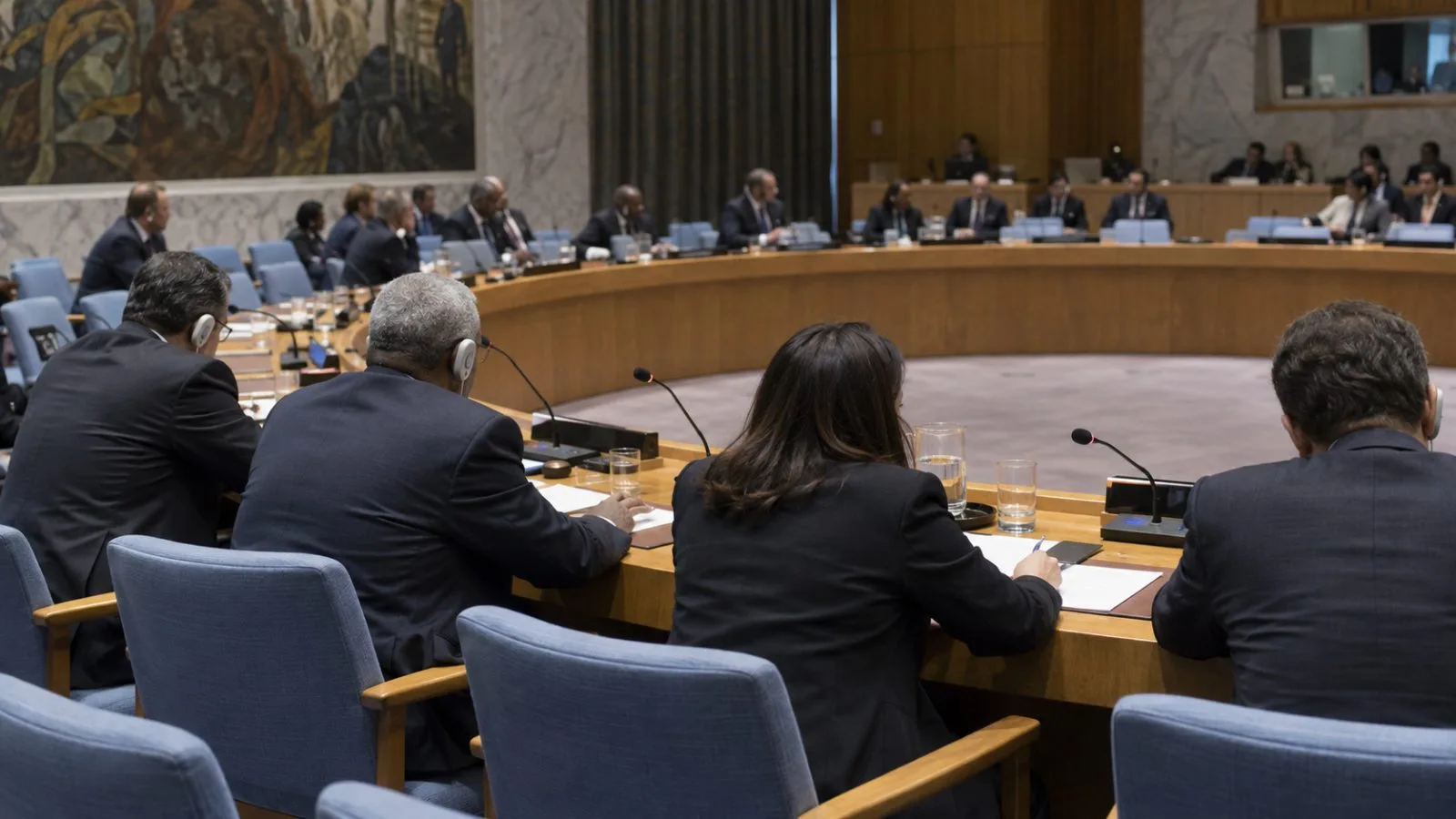 Delegates sit at microphones during a meeting at United Nations headquarters in New York. (AI-generated image / EconoTimes)