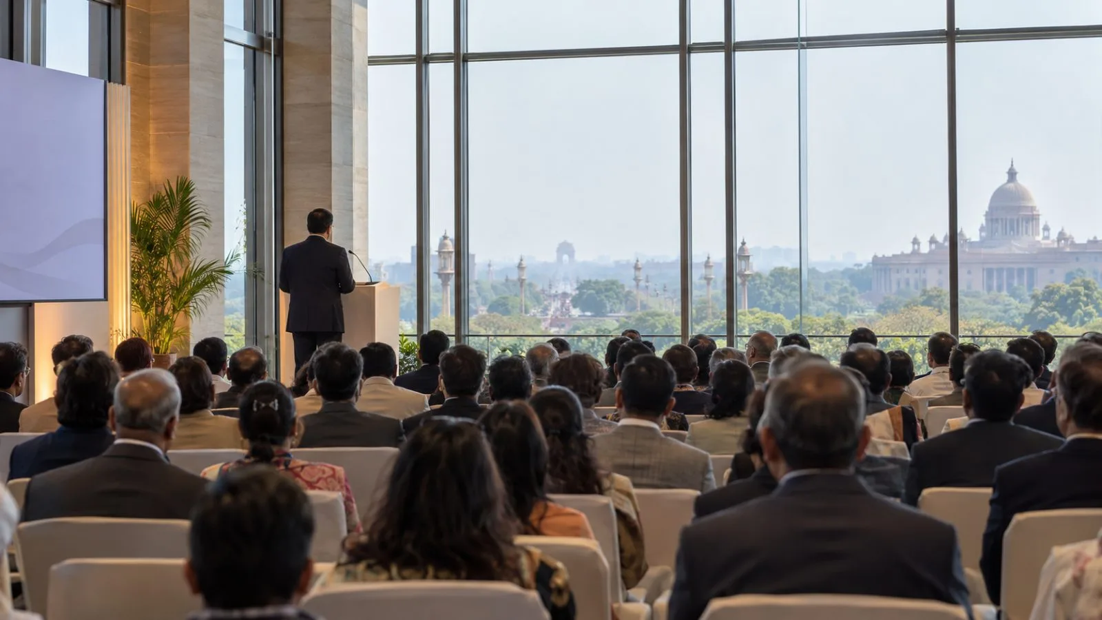 Attendees listen during a policy session at a conference hall in New Delhi. (AI-generated image / EconoTimes)