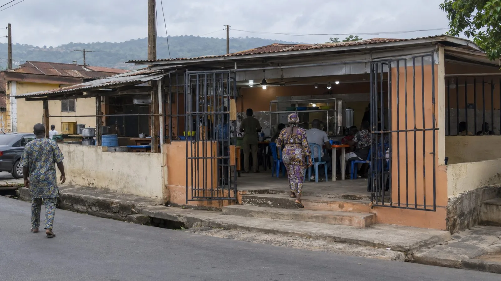 A restaurant entrance stands on a street in Ado-Ekiti, Nigeria, after a reported altercation. (AI-generated image / EconoTimes)