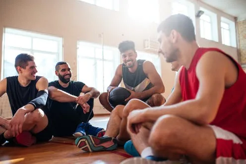 A group of basketball players talking and appearing to have fun. A recent study showed that college athletes benefited from special counseling designed for them. bernard/Shutterstock.com, CC BY-SA