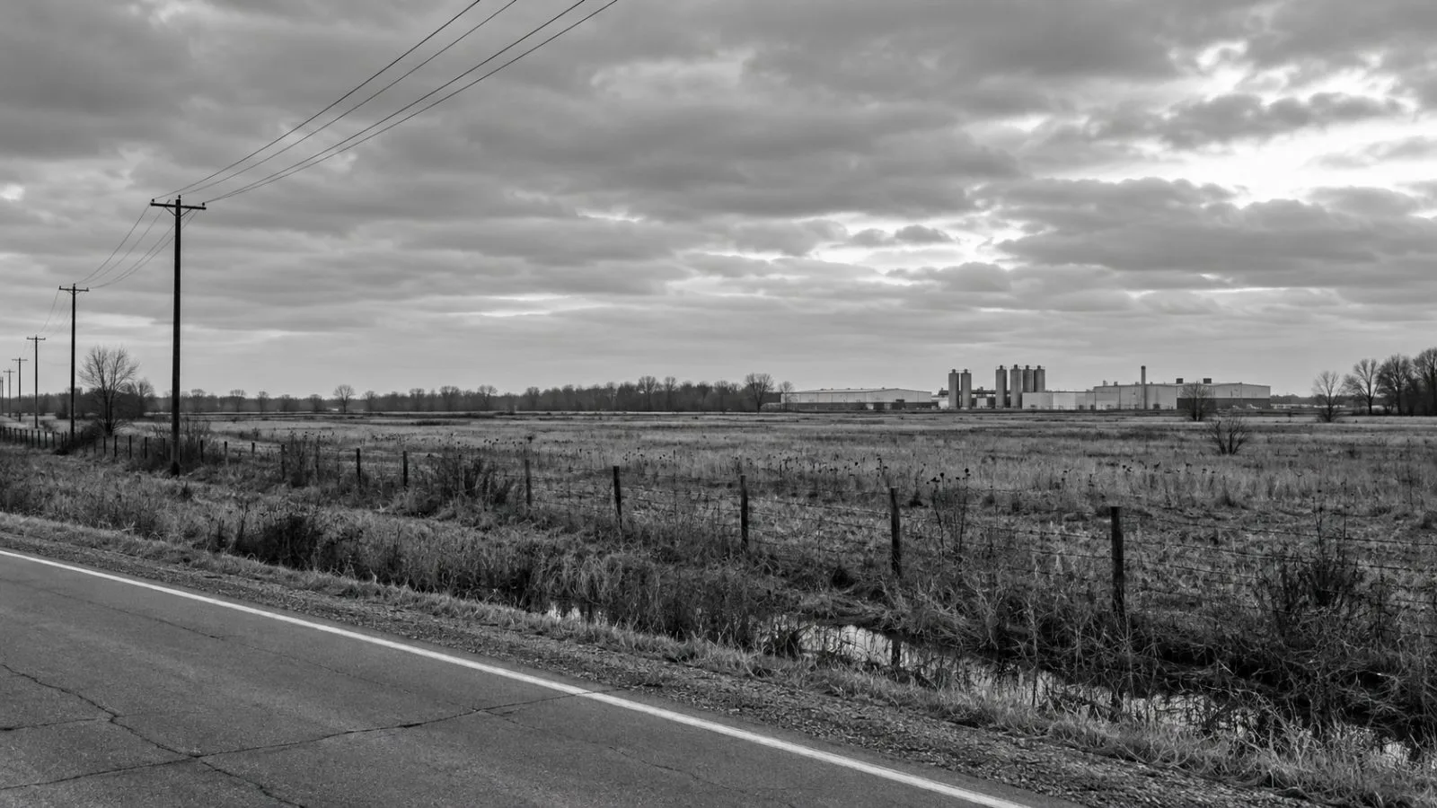 The proposed factory site is seen from a roadside in Tiffin, Ohio. (AI-generated image / EconoTimes)