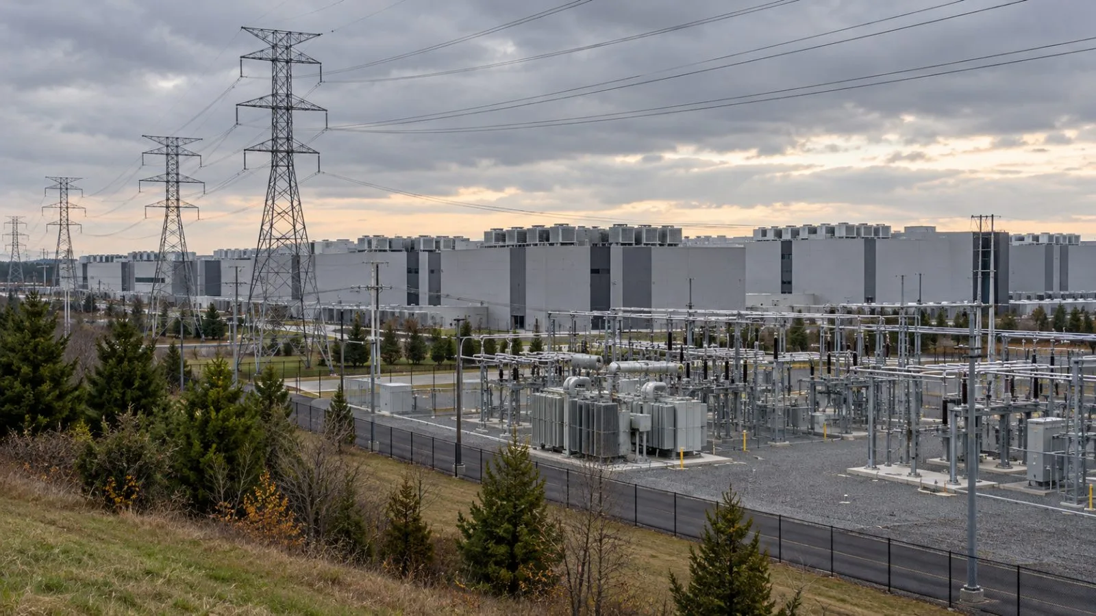 High-voltage lines cross a substation beside data centers in Ashburn, Virginia. (AI-generated image / EconoTimes)