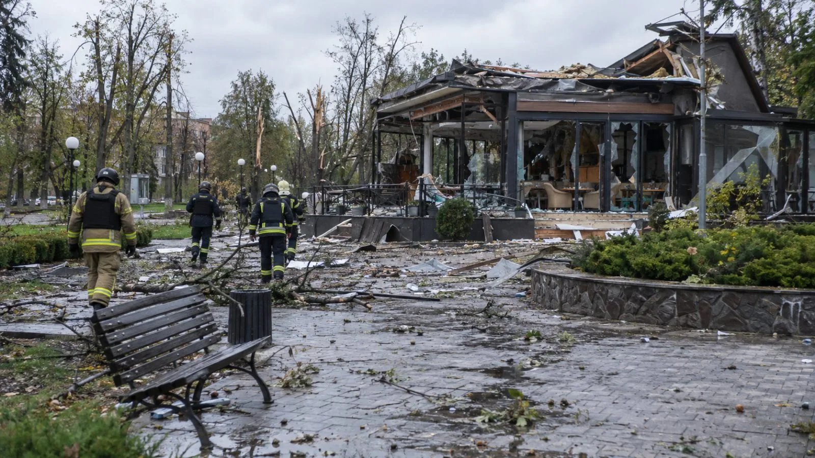 Broken branches and debris lie near a cafe in Nova Vodolaha's central park. (AI-generated image / EconoTimes)