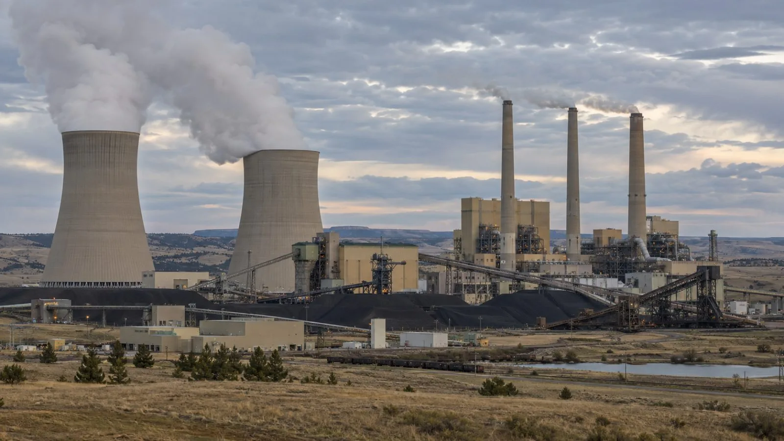 Cooling towers stand at the Colstrip coal-fired power plant in Montana. (AI-generated image / EconoTimes)