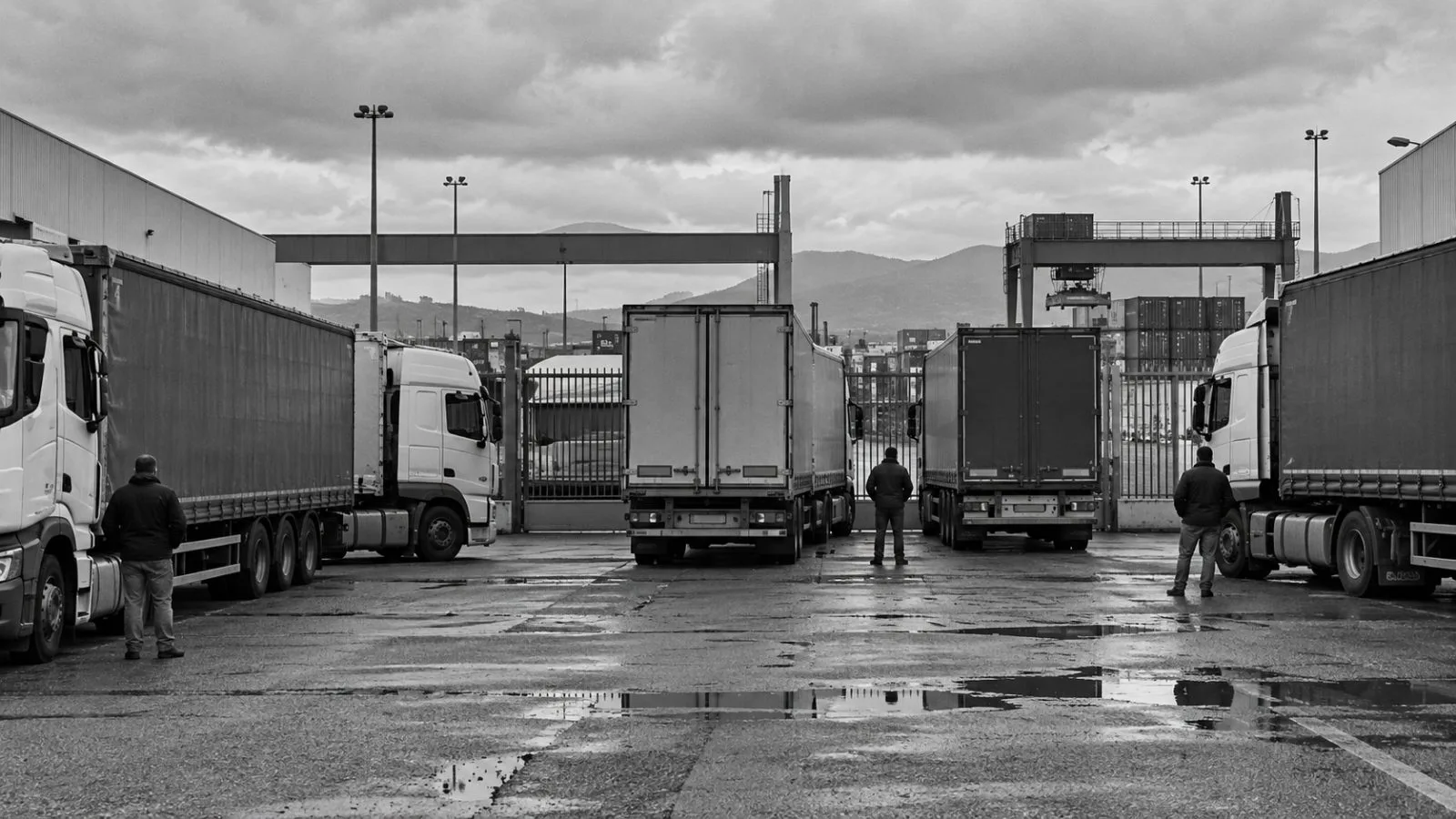 Trucks block the entrance to Interporto Sud Europa in Maddaloni, Italy. (AI-generated image / EconoTimes)