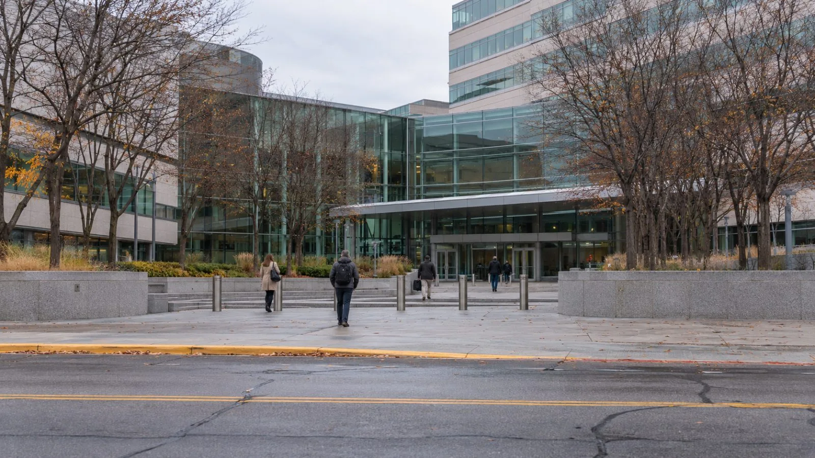 Employees cross the entrance plaza at 3M Center in St. Paul, Minnesota, on an overcast autumn morning. (AI-generated image / EconoTimes)