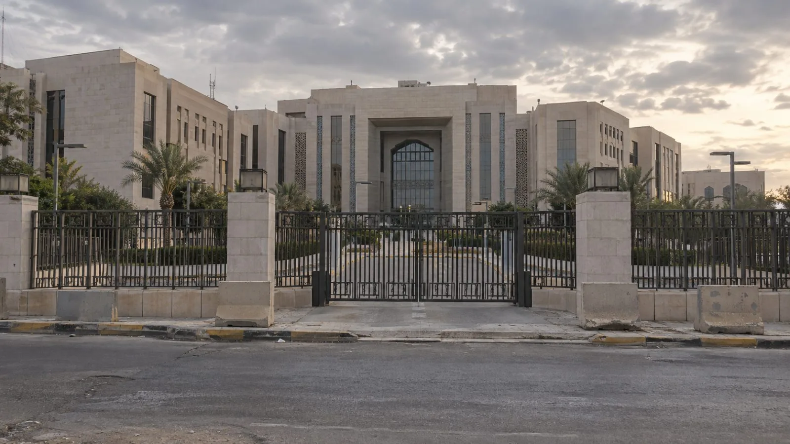 Concrete barriers line a guarded roadway in central Baghdad, Iraq. / EconoTimes.ai
