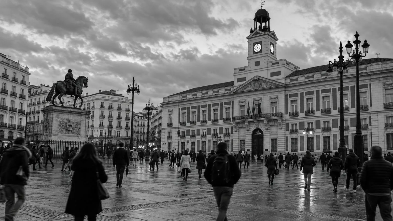 Pedestrians cross Puerta del Sol outside Madrid's regional government headquarters. (AI-generated image / EconoTimes)