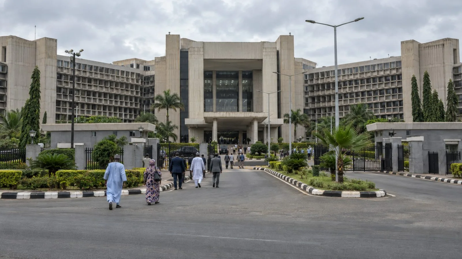 Visitors enter Abuja's Federal Secretariat complex, home to the Nigerians in Diaspora Commission. (AI-generated image / EconoTimes)
