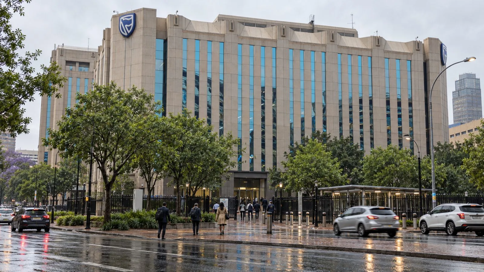 Pedestrians pass the Standard Bank Centre on Simmonds Street in Johannesburg. / EconoTimes.ai