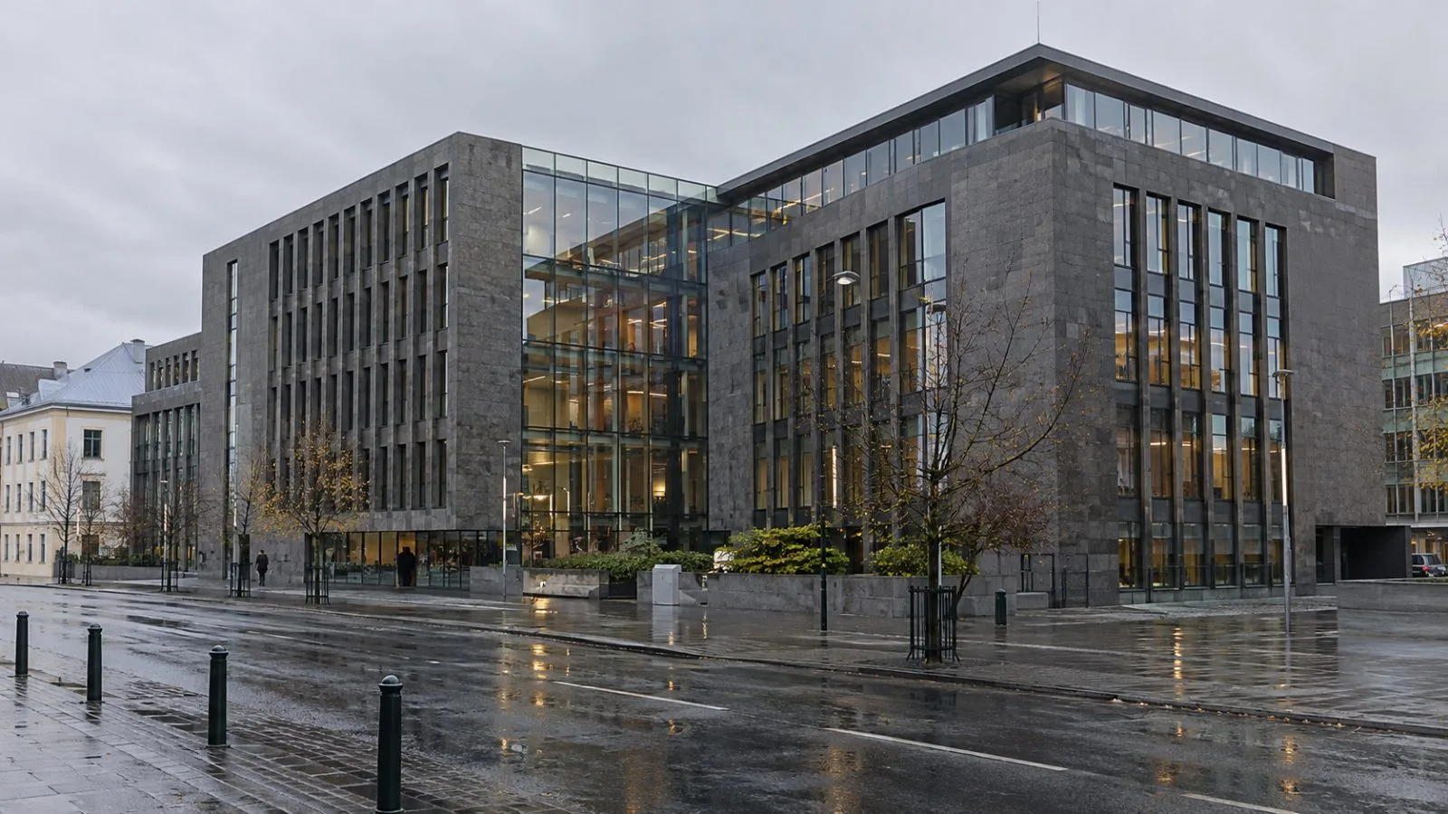A bank headquarters stands along a wet street in central Reykjavík, Iceland. (AI-generated image / EconoTimes)