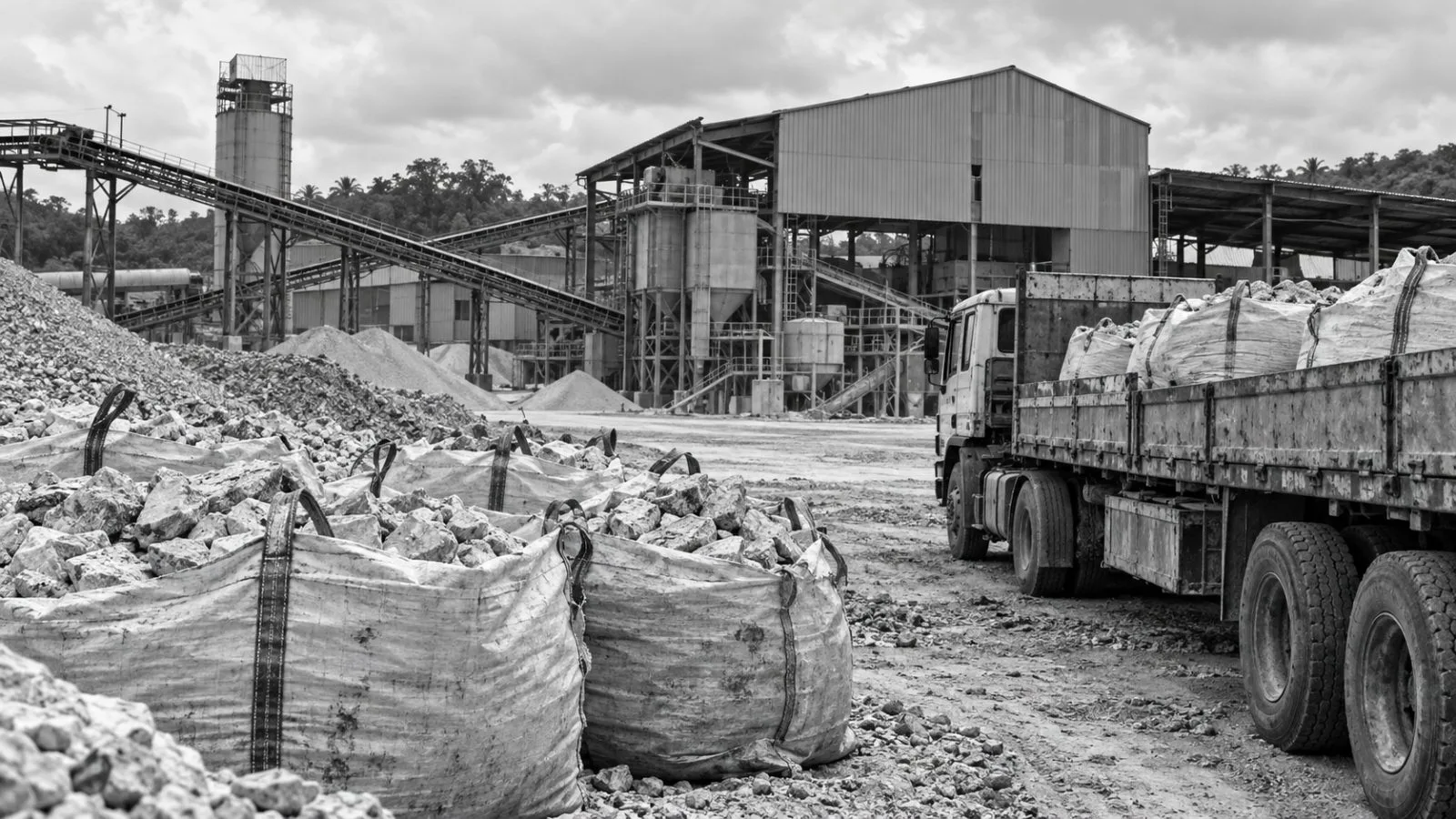 A trailer truck stands beside sacks of lithium-bearing rock at a processing site in Ogere, Nigeria. / EconoTimes.ai