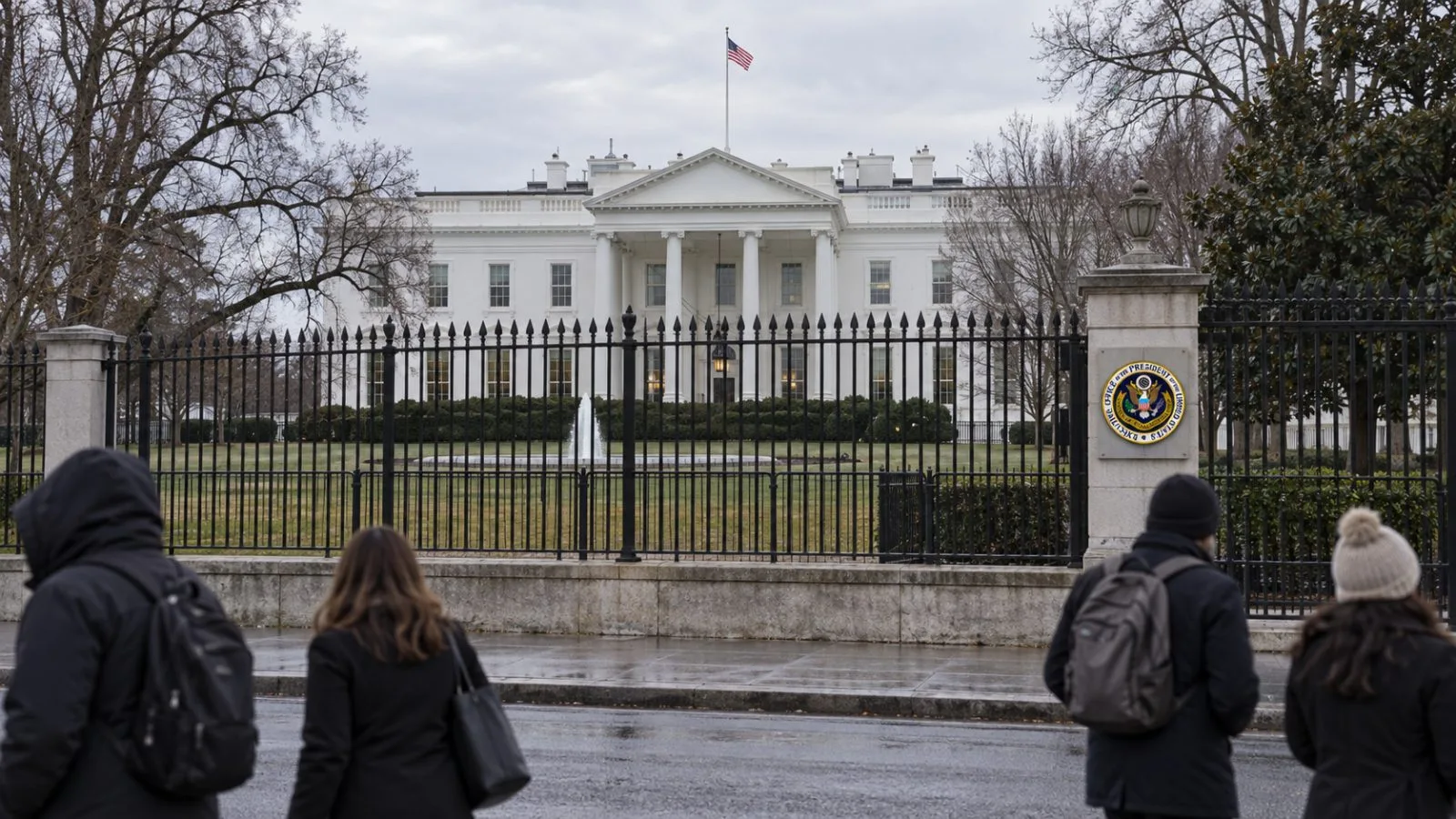 Pedestrians pass the White House complex on Pennsylvania Avenue in Washington, D.C. / EconoTimes.ai