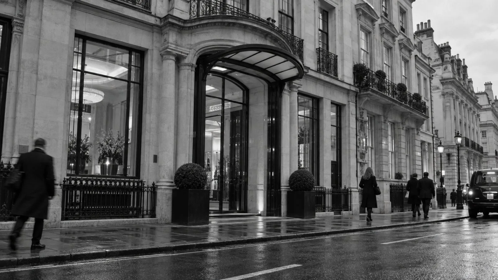 Pedestrians pass an office building on Park Street in London’s Mayfair district (AI-generated image / EconoTimes)