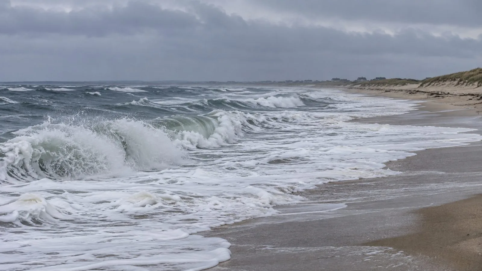 Atlantic swells break along Nantucket’s South Shore under a low gray sky. (AI-generated image / EconoTimes)
