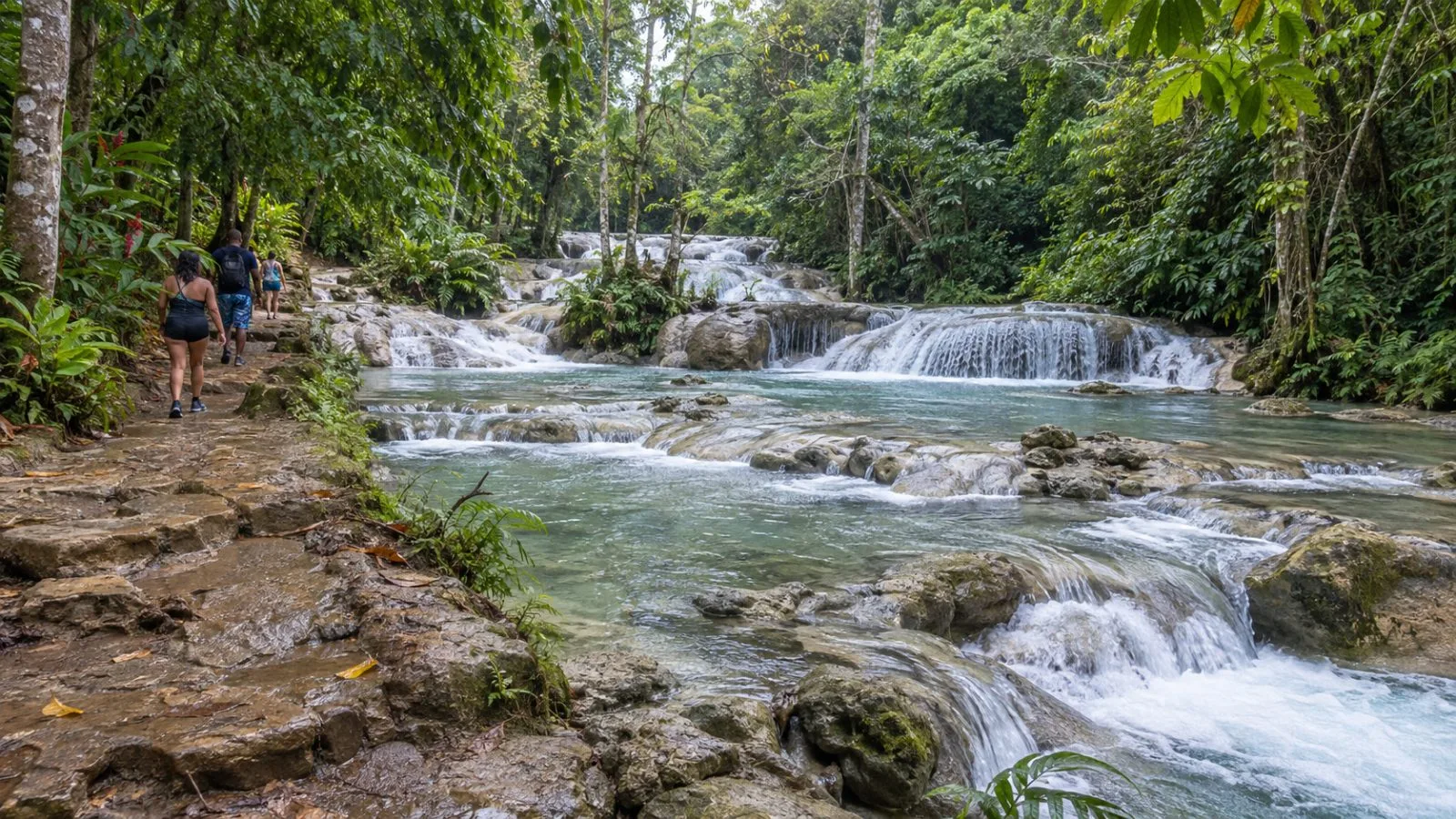 Visitors approach the river at Little Dunn’s River in St. Ann, Jamaica. (AI-generated image / EconoTimes)