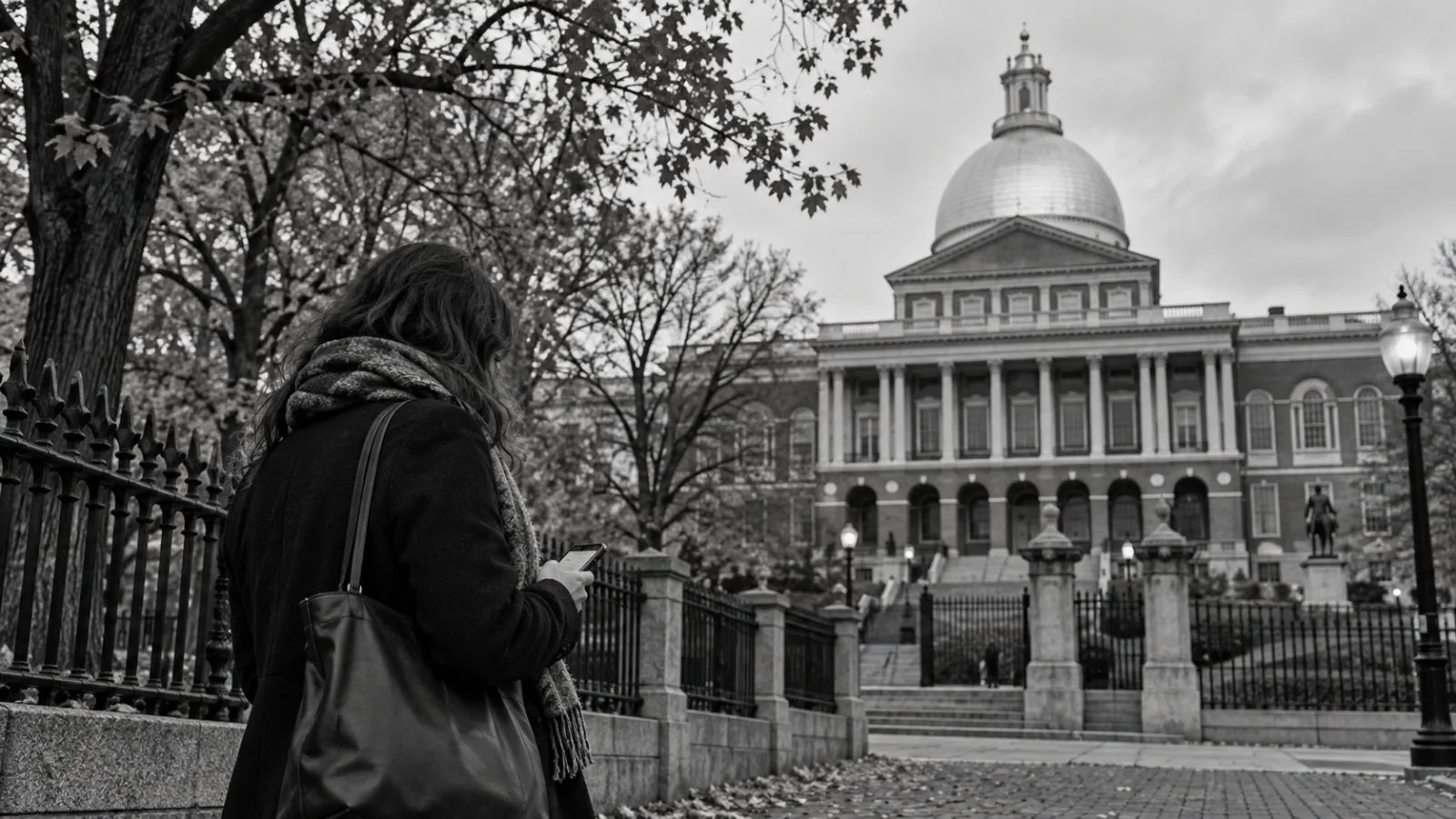 A passerby checks a smartphone near the Massachusetts State House in Boston. (AI-generated image / EconoTimes)