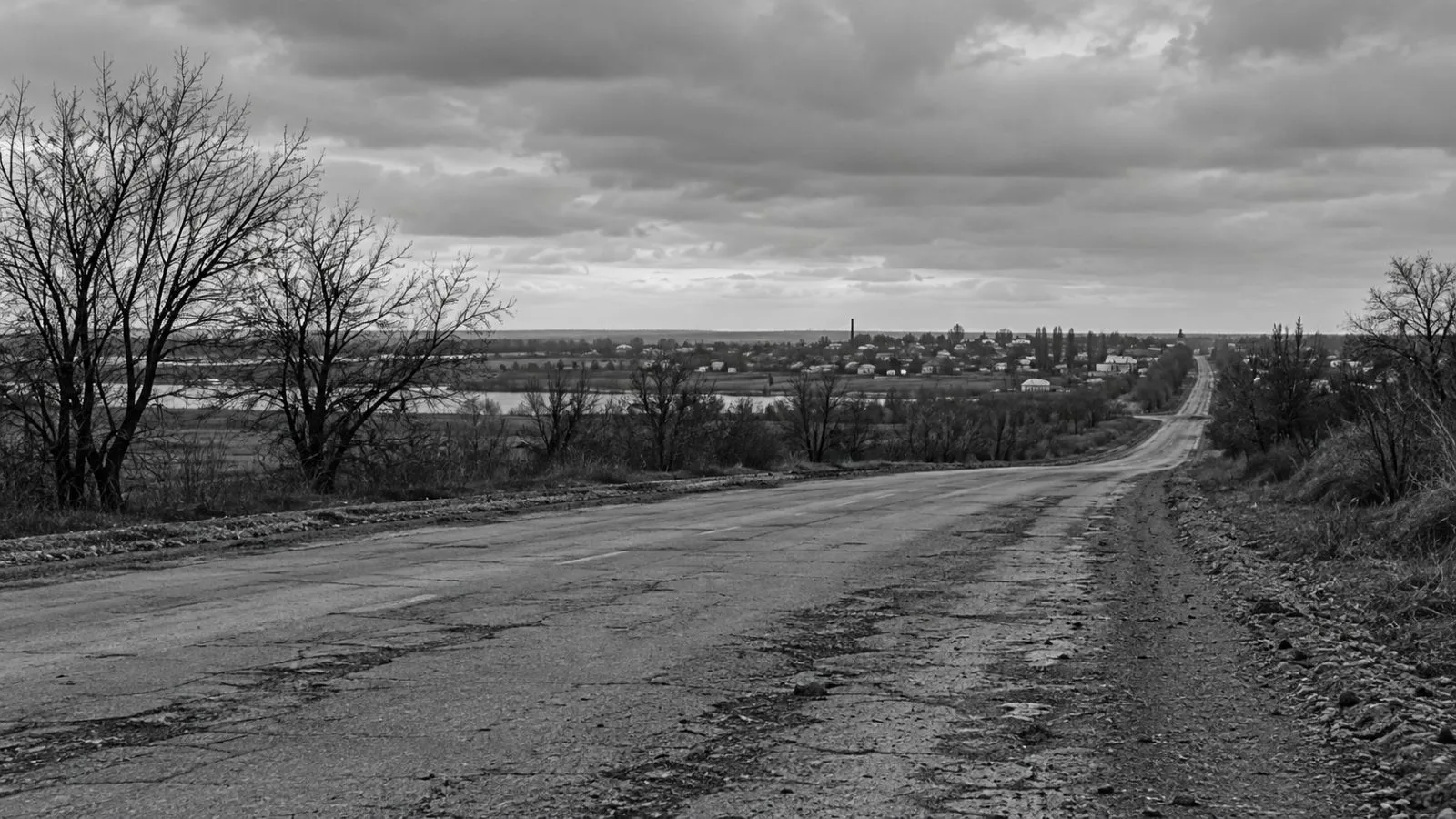 The road into Oleshky lies quiet beneath overcast skies in southern Ukraine. (AI-generated image / EconoTimes)