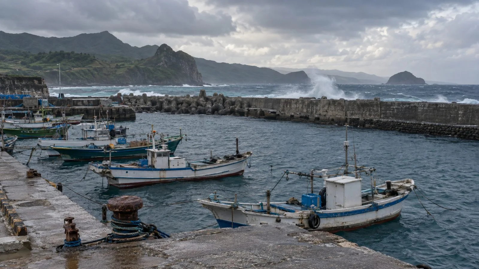 Fishing boats sit moored at Basco Port beneath overcast skies in Batanes. (AI-generated image / EconoTimes)