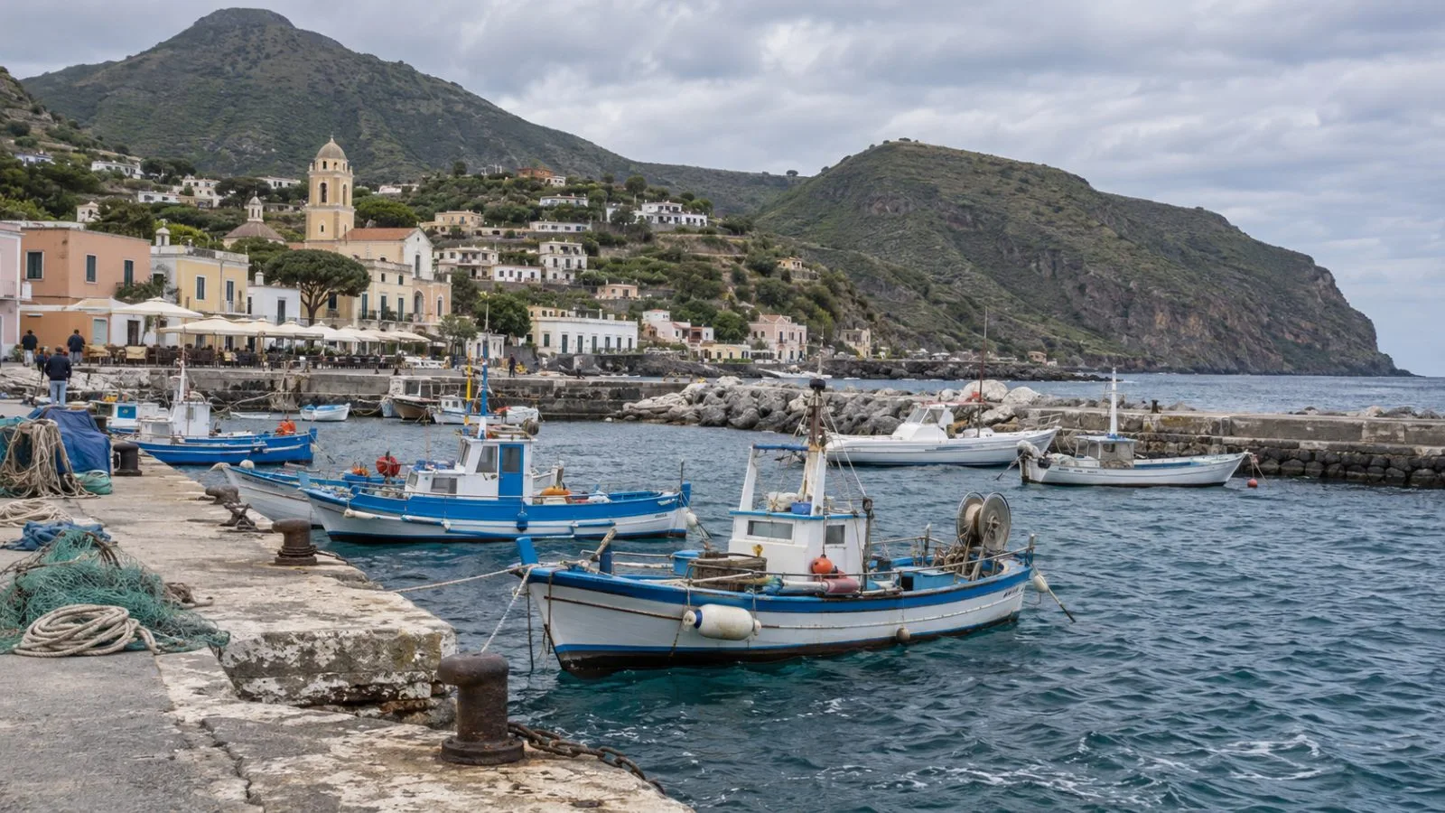 Small waves lap against a harbor seawall in Leni on Italy’s Salina island. (AI-generated image / EconoTimes)